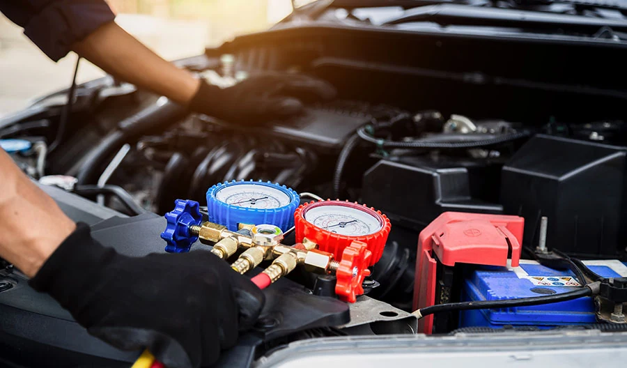 Technician performing car ac maintenance service