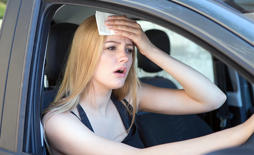Women wiping sweat off forehead
