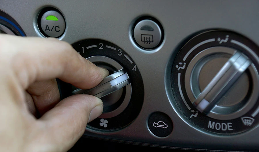 Person turing up their car AC fan