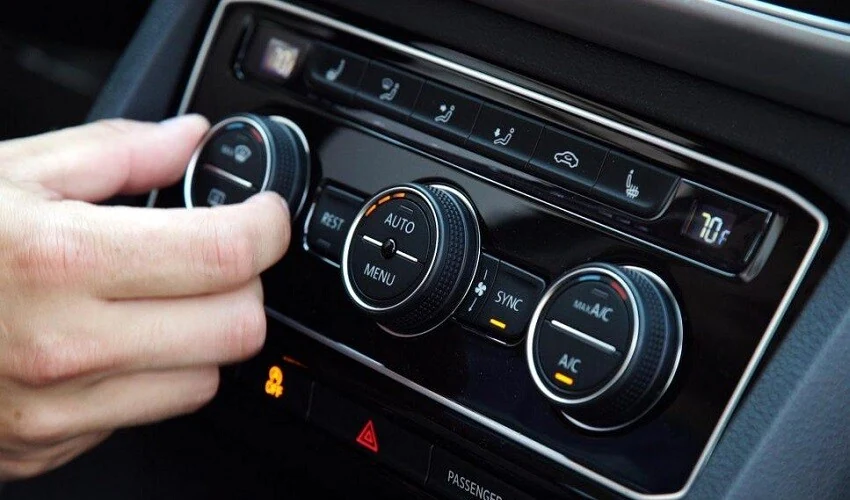 Man turning on car air conditioning
