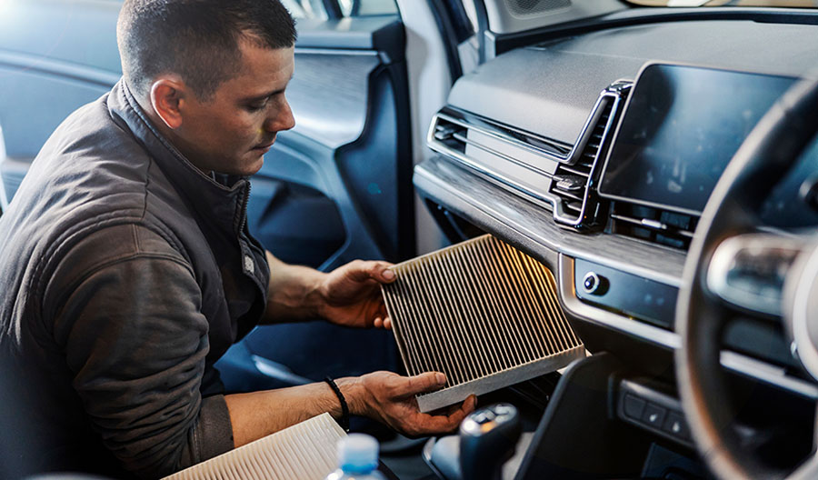 Man Replacing his Car Cabin Air Filter